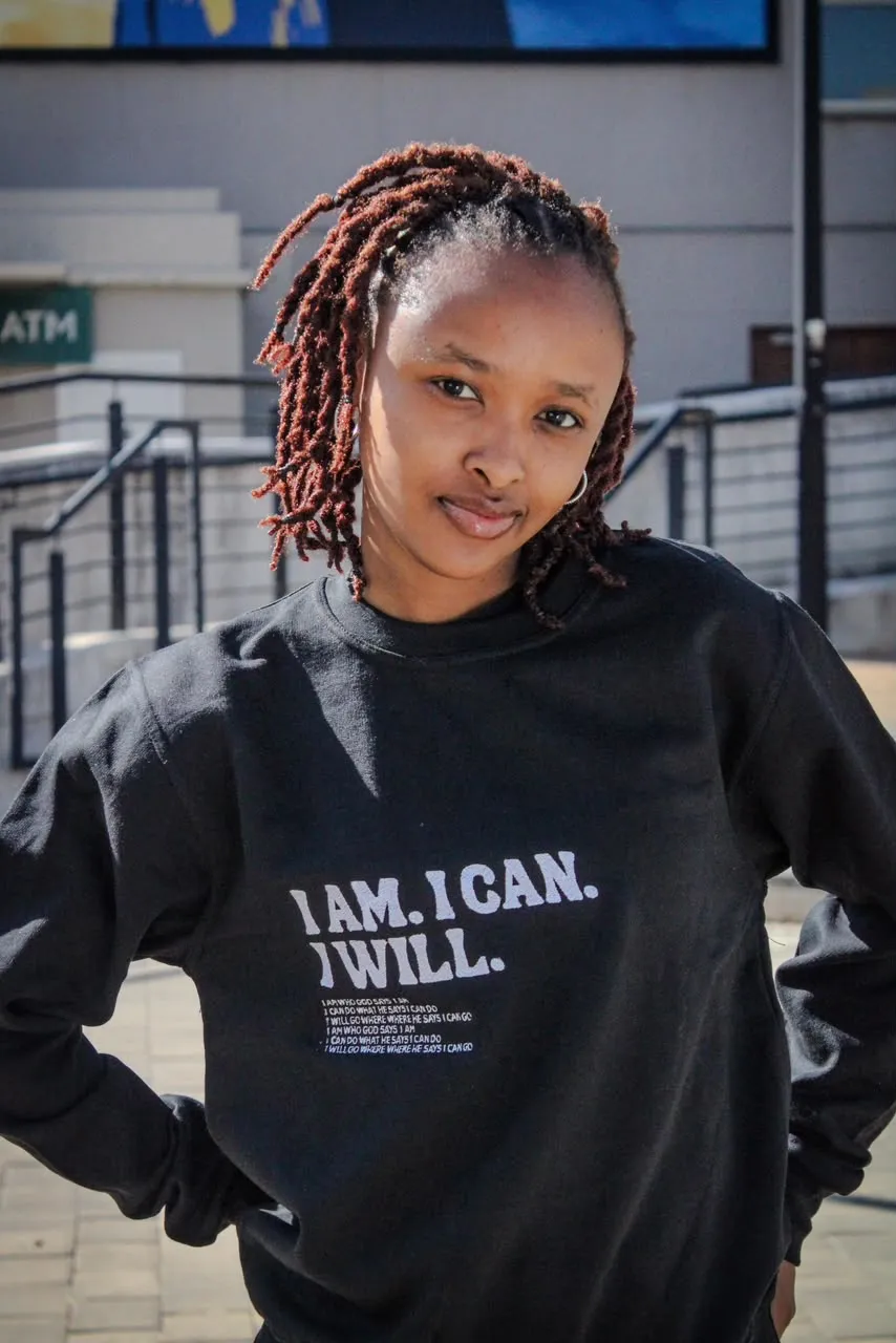 Student in the "I Am. I Can. I Will." sweater, hands on hips